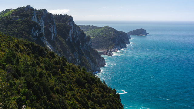 Beautiful view over the Tinetto, Tino and Palmaria islands as seen from a hiking trail in Porto Venere, La Spezia, Italy, on a hazy summer day.