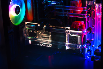 Inside a high performance computer. Computer circuit board and CPU cooling fans illuminated by...