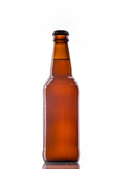 Bottle of white belgian beer over white background with reflection