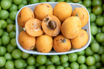 Ripe loquat or Eriobotrya japonica fruits in the greek vegetable fruit shop in May.