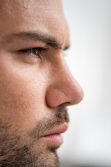 portrait of handsome man with sweaty face suffering from heat on white background