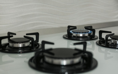 Gas burners with blue flame on modern stove