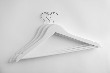 Empty clothes hangers on white background, top view