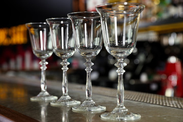 Row of empty clean glasses on counter in bar