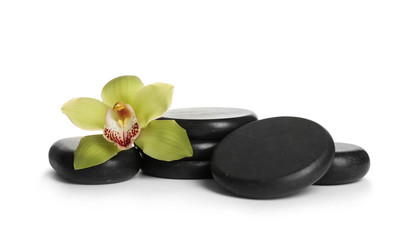 Spa stones with beautiful orchid flower on white background