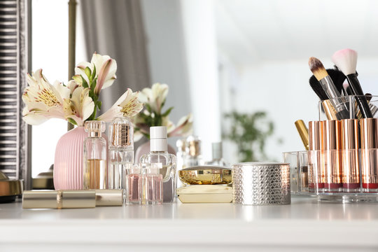 Luxury Makeup Products And Accessories With Perfumes On Dressing Table