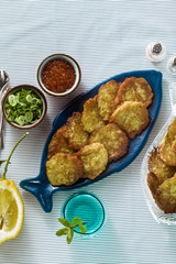 fish patties served on the table with red caviar, green onions and sour cream. fish homemade dish