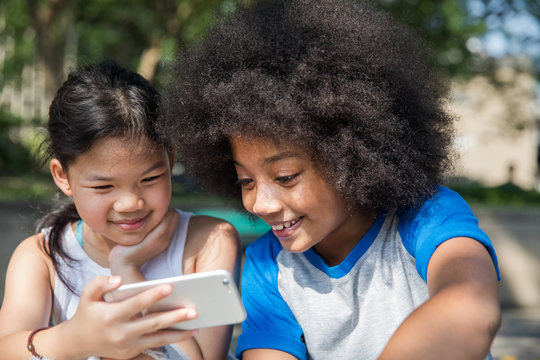 Two girls watching a video on phone together