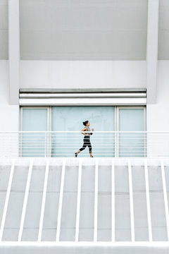 Beautiful asian woman running in the city.