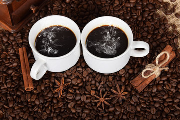 two white cups with black coffee