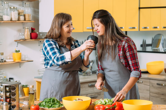 Family leisure in kitchen. Culinary practice. Healthy homemade food. Mother sharing cooking skills with daughter.