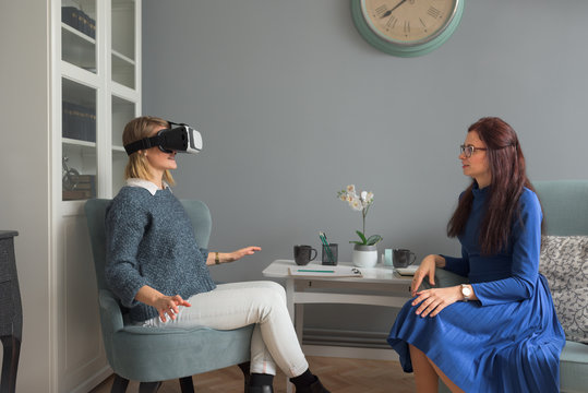 Therapist treating her patient using virtual reality gear
