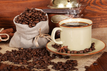freshly ground and brewed black coffee in a brown cup