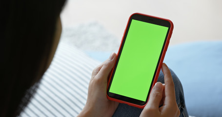 Woman hold with cellphone with green screen