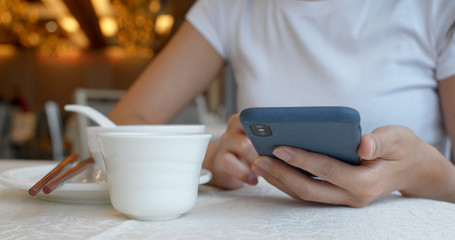 Woman use of cellphone in chinese restaurant