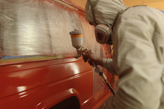 Man at service painting auto