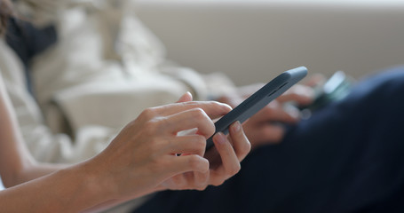 People use of mobile phone together at home