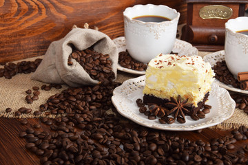 retro cups with hot coffee and a cookie with vanilla chocolate cream