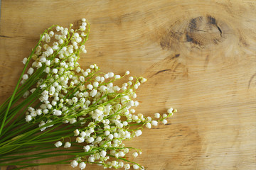 bouquet of fresh lilies of the valley on a wooden backgroundSpring mood