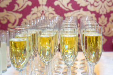 glasses of champagne on the table on the background of vintage wallpaper