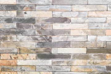 brick wall , texture of multi colored stone blocks closeup