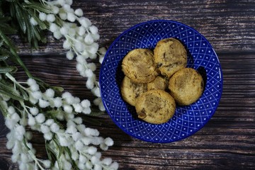 Chocolate chips cookies on a wooden background.