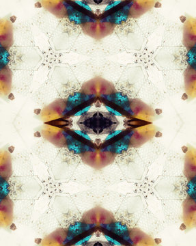 Drawing made with colorful crystals inside old kaleidoscope