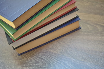 stack of books on wooden background