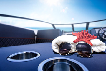 White towel and summer sunglasses on boat. Free space for your decoration and summer sunny day. 