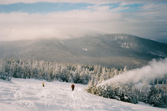 Skiers enjoy some early morning sunshine on their first decent.