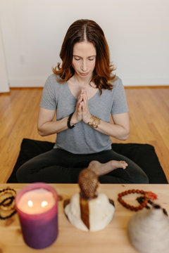Beautiful woman practicing meditation at home