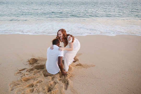 Affectionate, happy just-married couple together at sunset on th