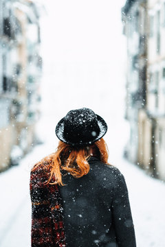 potyrait of a woman in a snowy city landscape