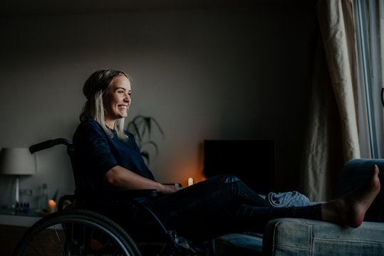 portrait of a smiling girl sitting in a wheelchair