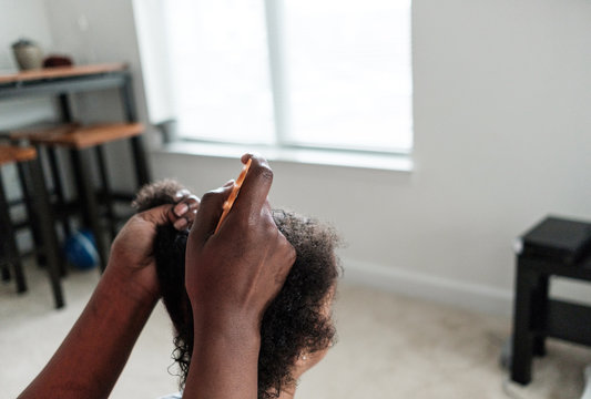 Mother doing her daughters hair