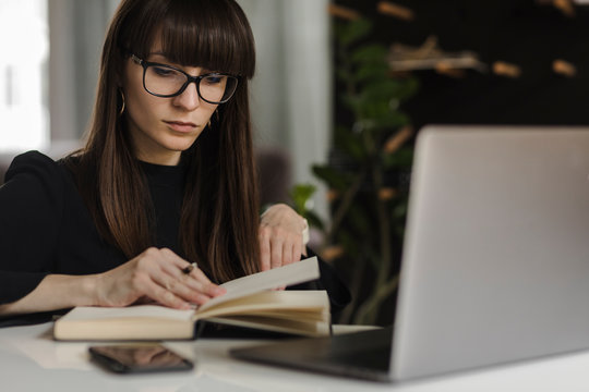 Young woman taking notes