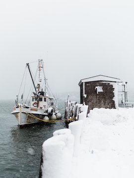 A fishing boat sits in a Maine harbor while a winter noreaster hits New England.