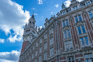 Fototapeta premium View of the bell towers and the Chambre de Commerce building in Lille.The belfry, 76 m high, of the Neo-Flemish style, is the symbol of the city of Lille.