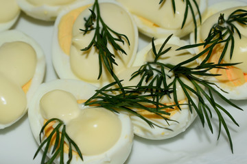 boiled eggs with parsley and dill on a plate