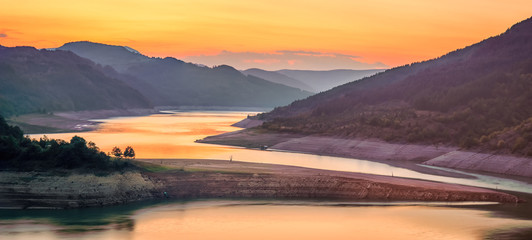 Amazing view of curvy, meandering Zavoj lake on Old mountain at golden hour during it's minimal water level panorama