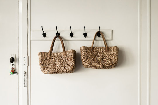 woven natural fibre baskets on wall hooks