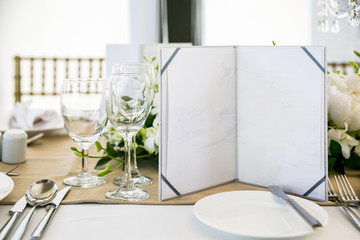 Empty wine glasses in restaurant with card
