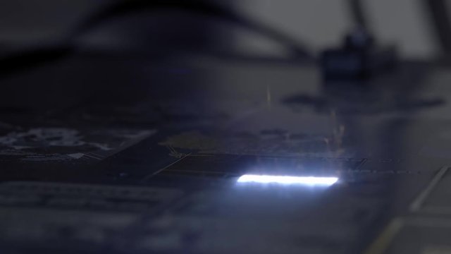 laser engraving on metal. Make a jewel. New technologies in metal processing and jewelry. Glowing laser beam burns on the metal. Macro, clouse up