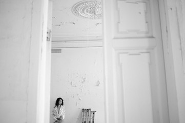 Young woman in a blouse in an abandoned room