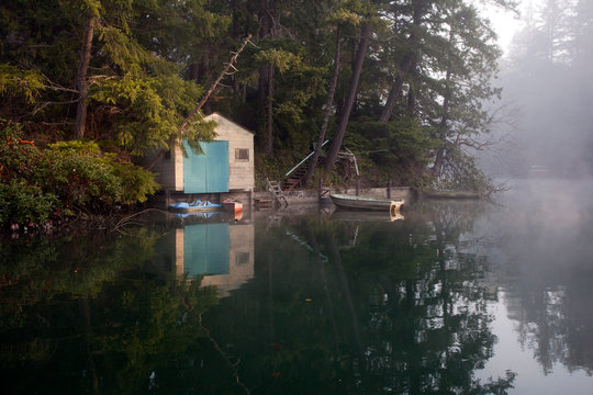 Boathouse and boats on the shore of Fletcher Bay in Bainbridge Island