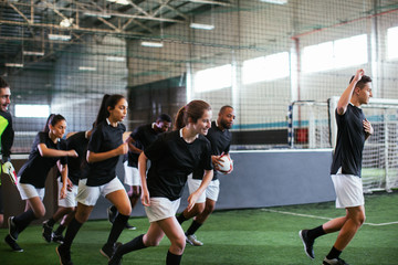 Soccer players going out to football field.