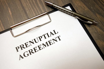 Clipboard with prenuptial agreement and pen on desk