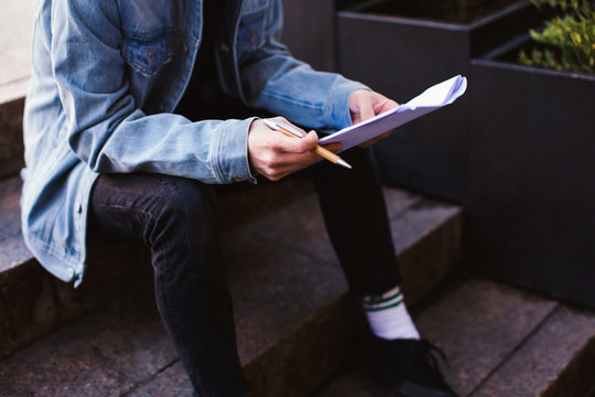 Actor reading script on the street.