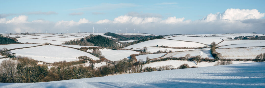 Wind farm on a snow covered hillside. Shirwell, Devon, UK.