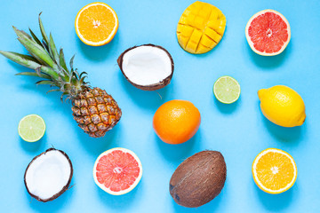 Tropical fruits summer concept flat lay on the blue background. Top view 